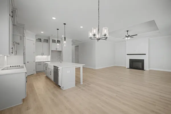 a kitchen with stainless steel appliances granite countertop a sink a stove and a refrigerator