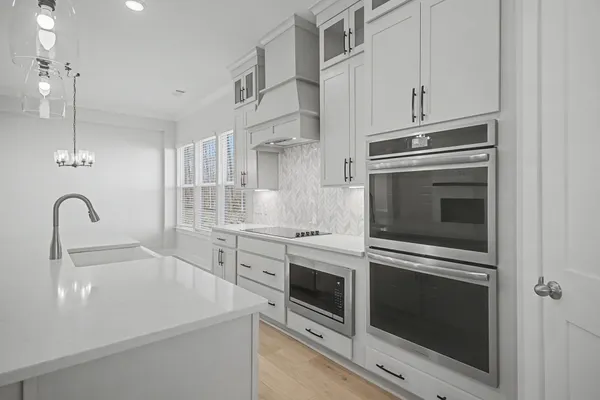 a kitchen with sink and cabinets