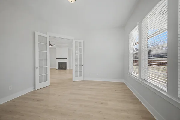 wooden floor in an empty room with a window