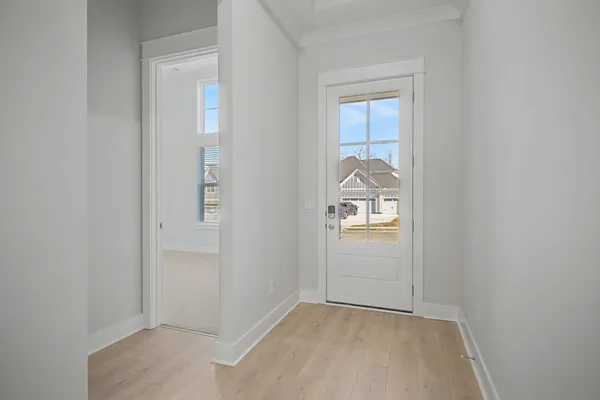a large white kitchen with kitchen island a sink stainless steel appliances and cabinets