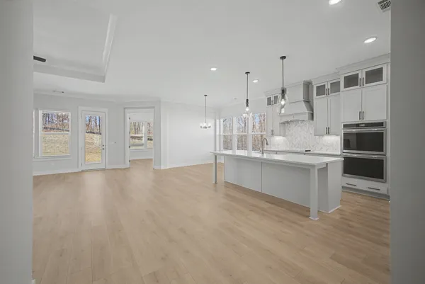 wooden floor in an empty room with a fireplace