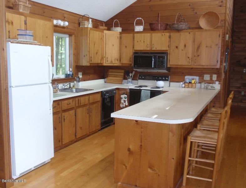155 Bonny Rigg Hill Road Becket, MA 01223 - Photo 12 of 21 a kitchen with stainless steel appliances a stove a sink and a refrigerator
