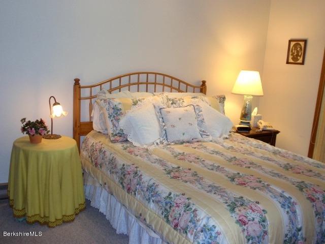 155 Bonny Rigg Hill Road Becket, MA 01223 - Photo 15 of 21 a bedroom with a bed and a lamp