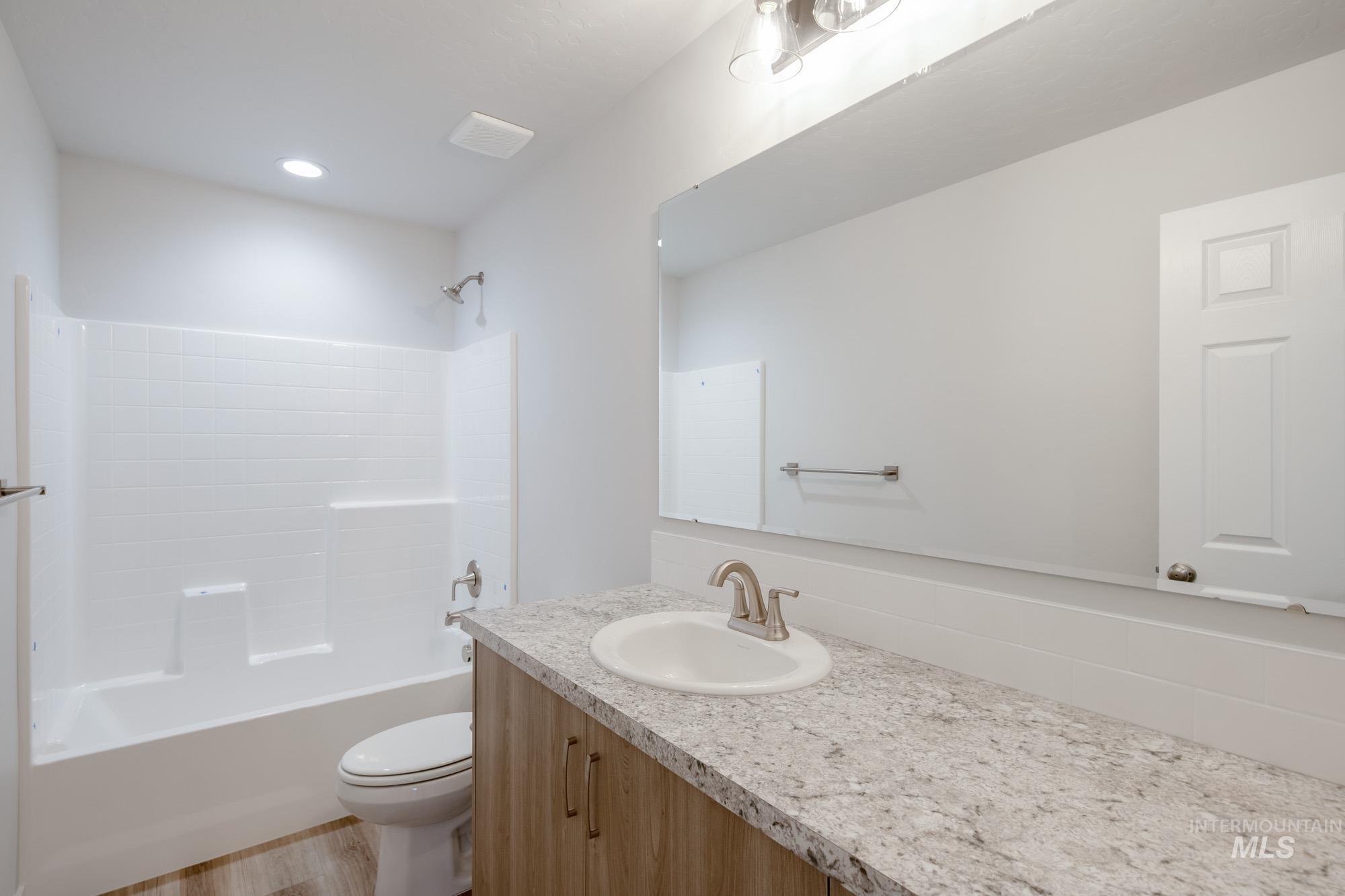 1711 North Birch Street Jerome, ID 83338 - Photo 15 of 16 Full bath featuring vanity, shower / tub combination, and light wood-style floors