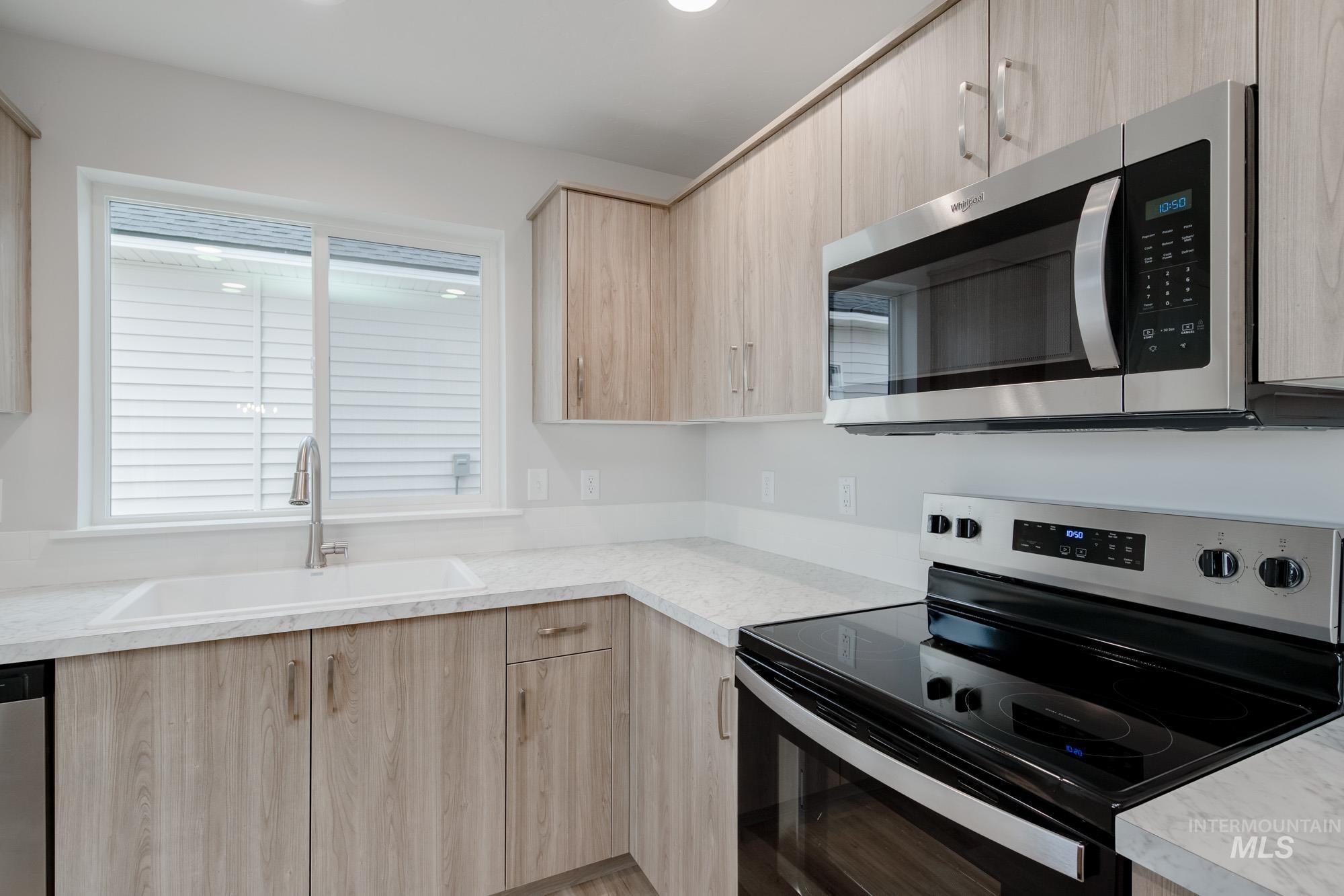 1711 North Birch Street Jerome, ID 83338 - Photo 4 of 16 Kitchen with stainless steel appliances, light wood finish cabinetry, and modern cabinets