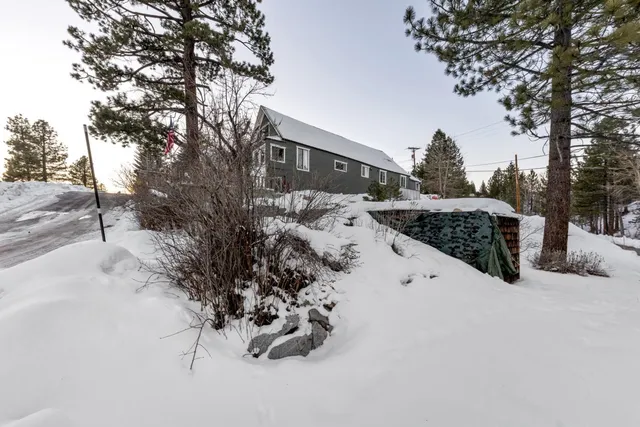 a view of garage yard and covered with snow