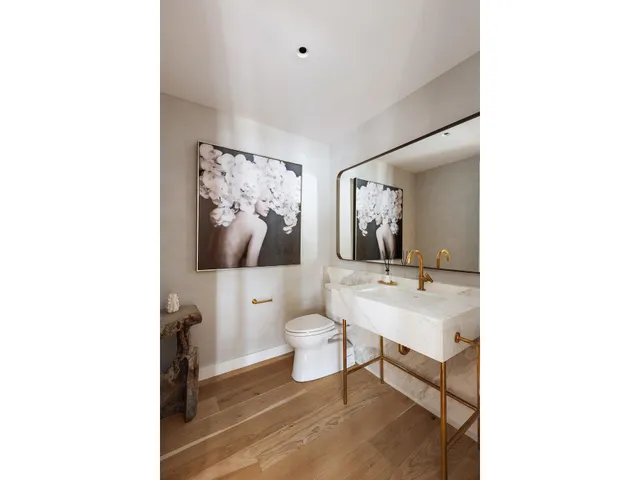 a view of a hallway with wooden floor and door