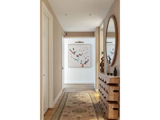 a bedroom with a bed and large windows