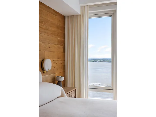 a bathroom with a double vanity sink a mirror and a bathtub