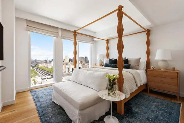 a living room with couch and a floor to ceiling window