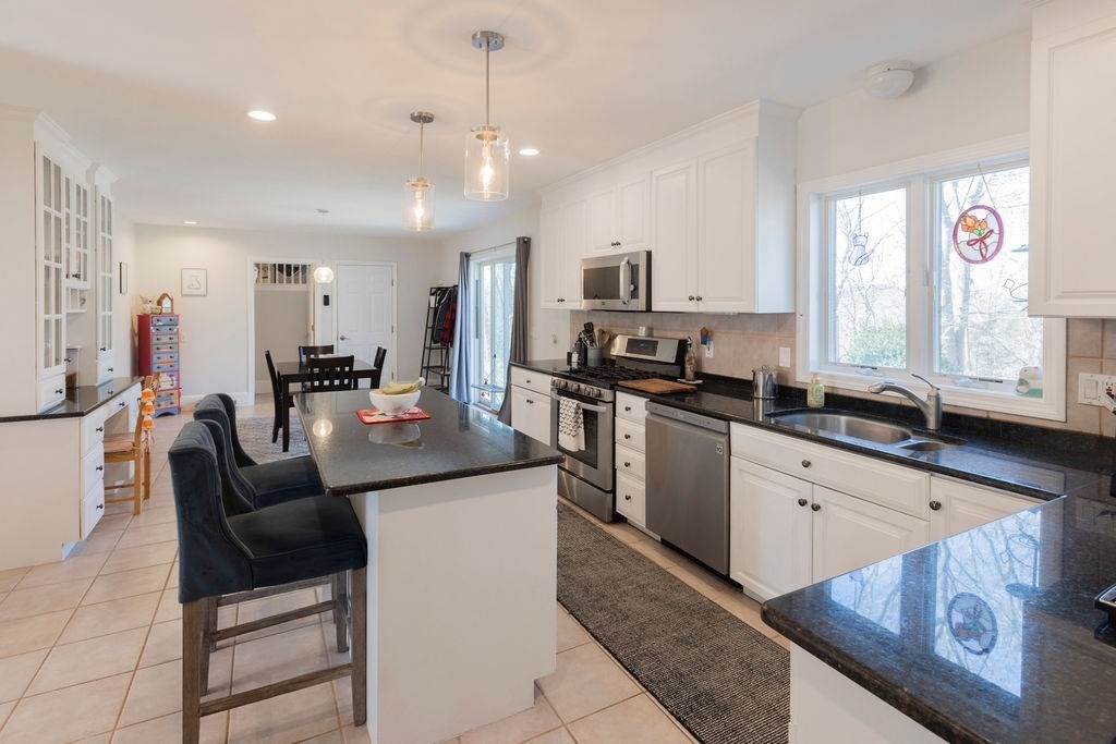 126 Lafayette Street Marblehead, MA 01945 - Photo 9 of 30 a kitchen with stainless steel appliances granite countertop a sink a stove and a refrigerator