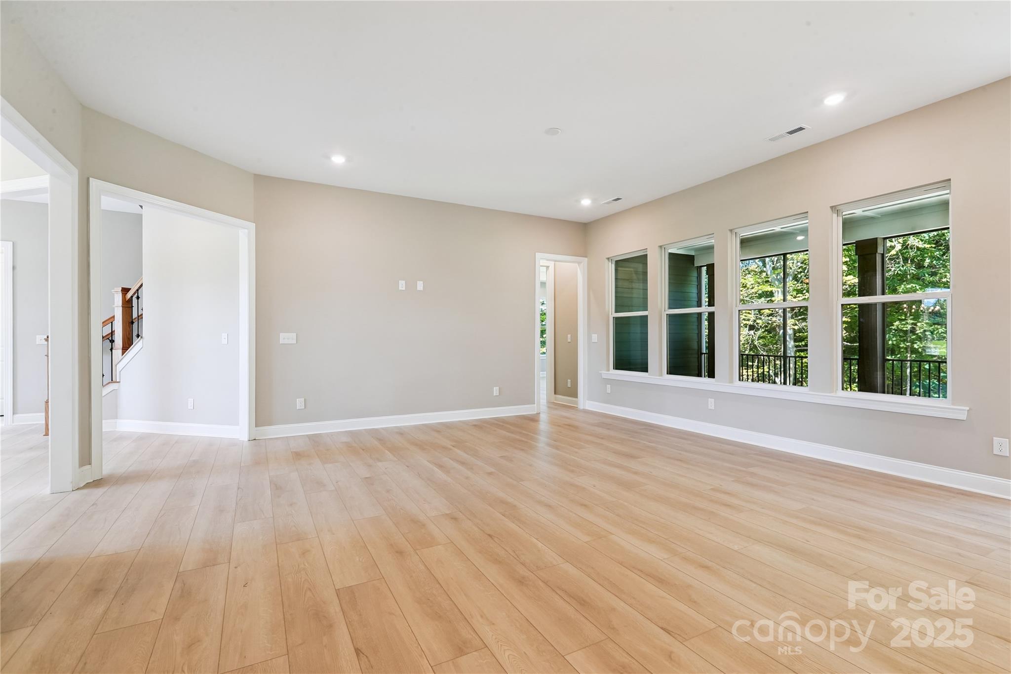 552 Fern Hill Road Mooresville, NC 28117 - Photo 11 of 12 a view of an empty room with wooden floor and a window