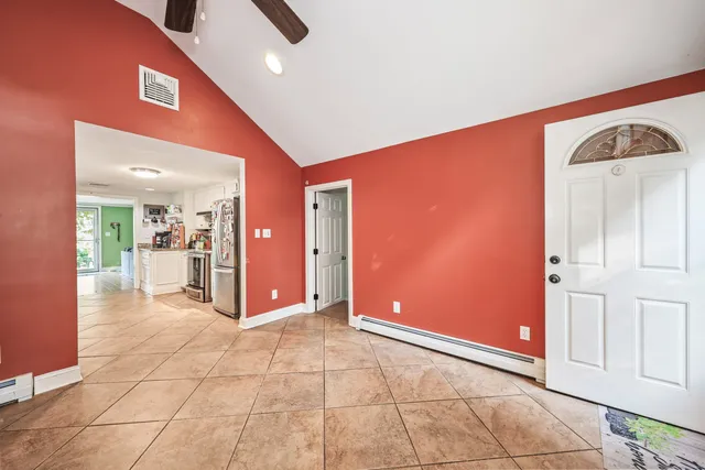 a view of a hallway with dining area