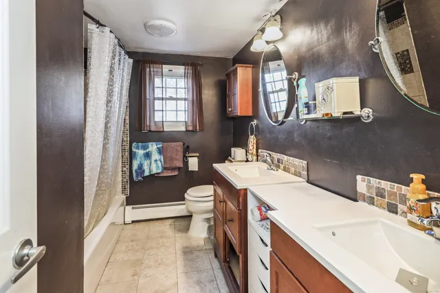 a bathroom with a sink a toilet and a mirror