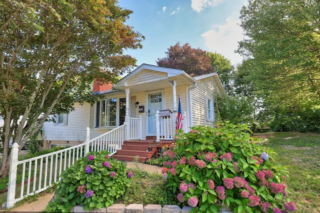 a front view of a house with a garden