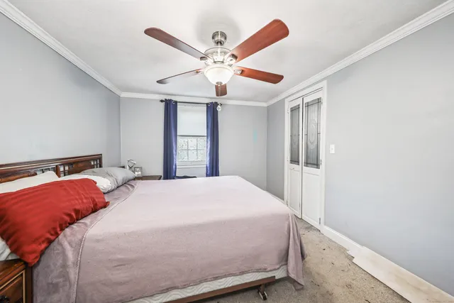 a bedroom with a large bed and a chandelier