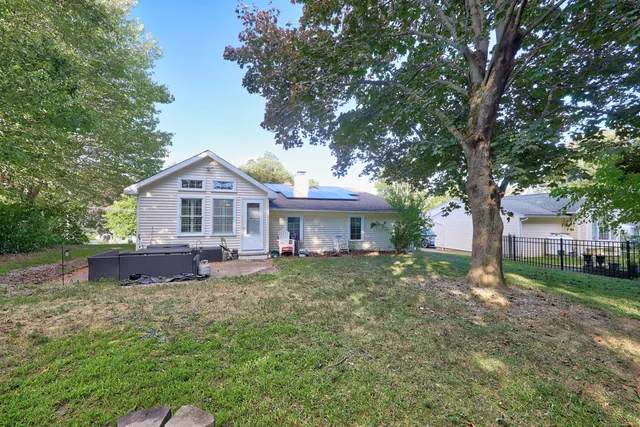 a front view of a house with patio and garden