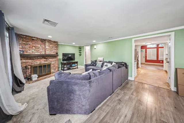 a living room with furniture large window and a fireplace
