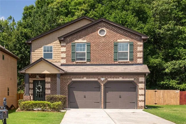 a front view of a house with a yard