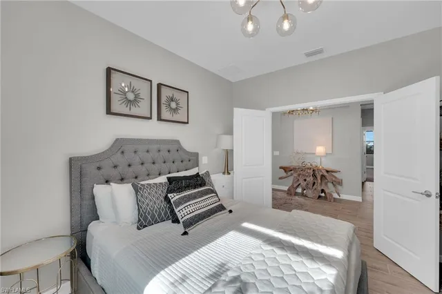 a bed room with furniture and a mirror