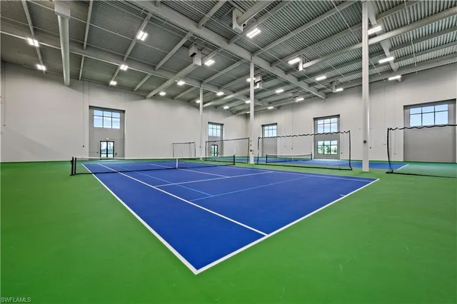 a indoor swimming pool with a table and chairs