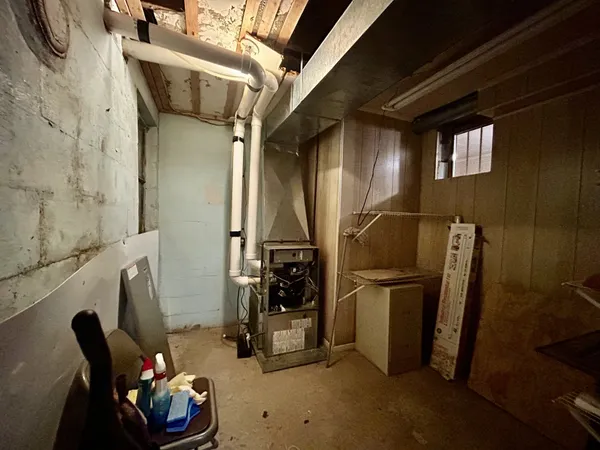 a hallway with a large window and furniture