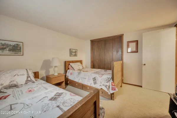a bedroom with a bed and hallway