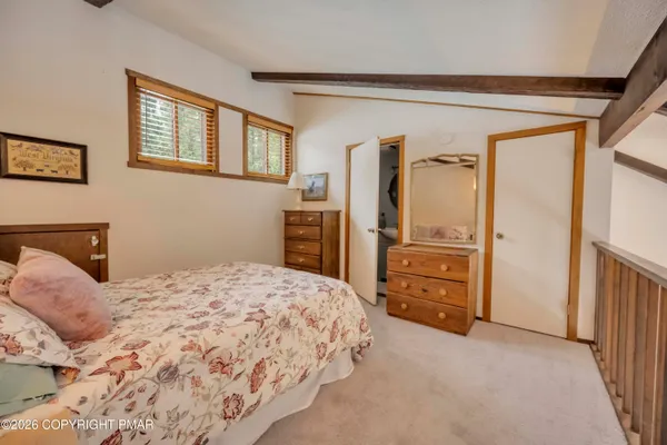 a bedroom with a bed and dresser