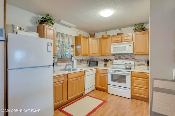 a white refrigerator freezer sitting inside of a kitchen