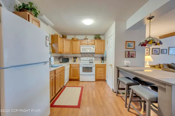 a kitchen with stainless steel appliances a stove a sink and a refrigerator