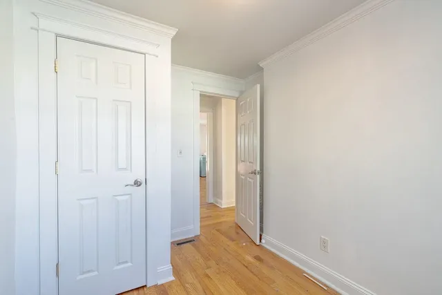 a view of room with wooden floor