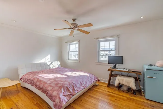 a bedroom with a bed a table and chair