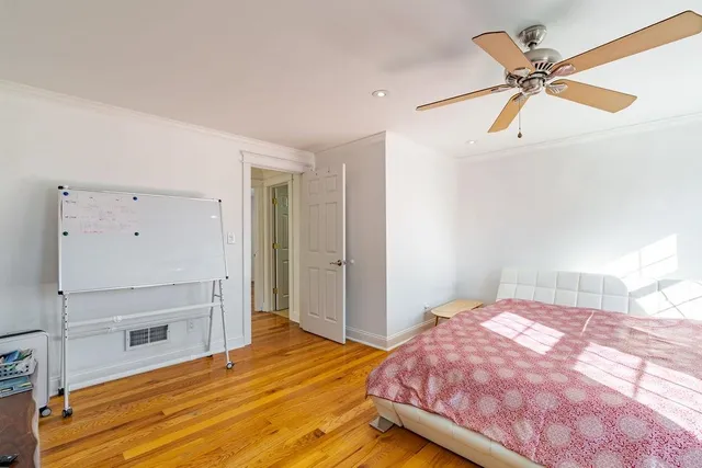 a bedroom with a bed and a dresser