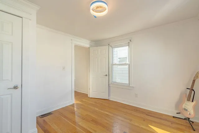 a view of room with window and wooden floor