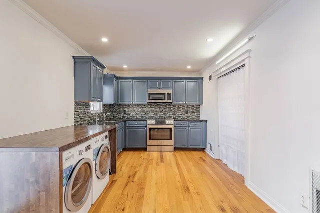 a kitchen with stainless steel appliances granite countertop a stove and a sink