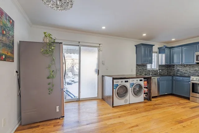 a kitchen with stainless steel appliances granite countertop a refrigerator and a stove top oven