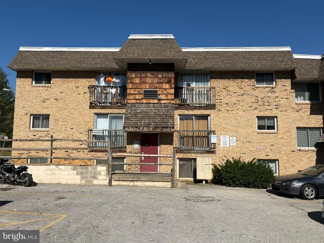 a front view of a house with parking space