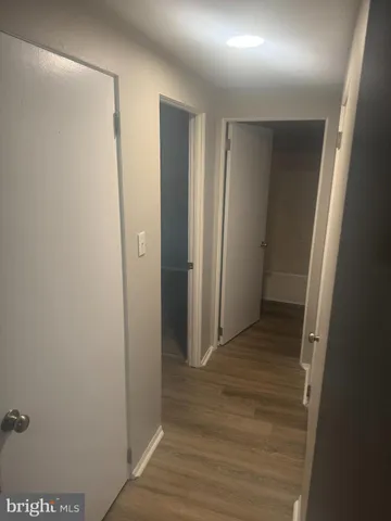 a view of hallway with wooden floor