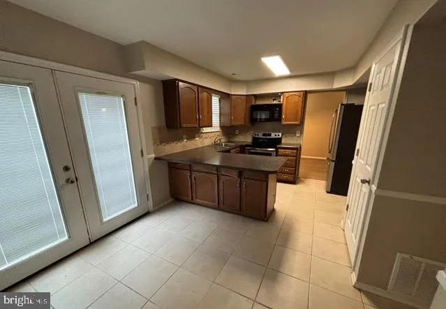 a kitchen with stainless steel appliances a refrigerator and a stove