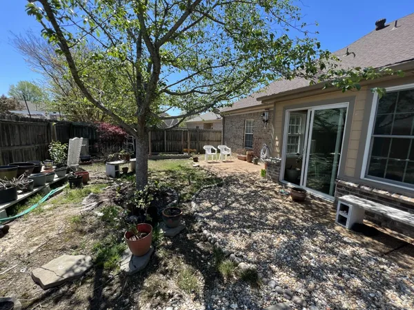 a view of a house with backyard sitting area and garden
