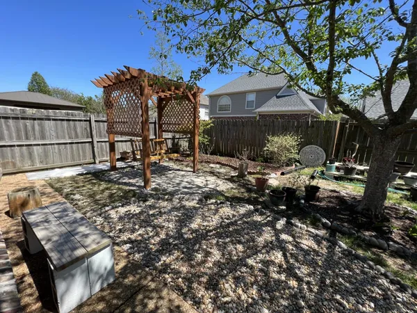 a backyard of a house with table and chairs