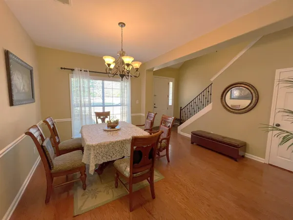 a view of a dining room with furniture and chandelier