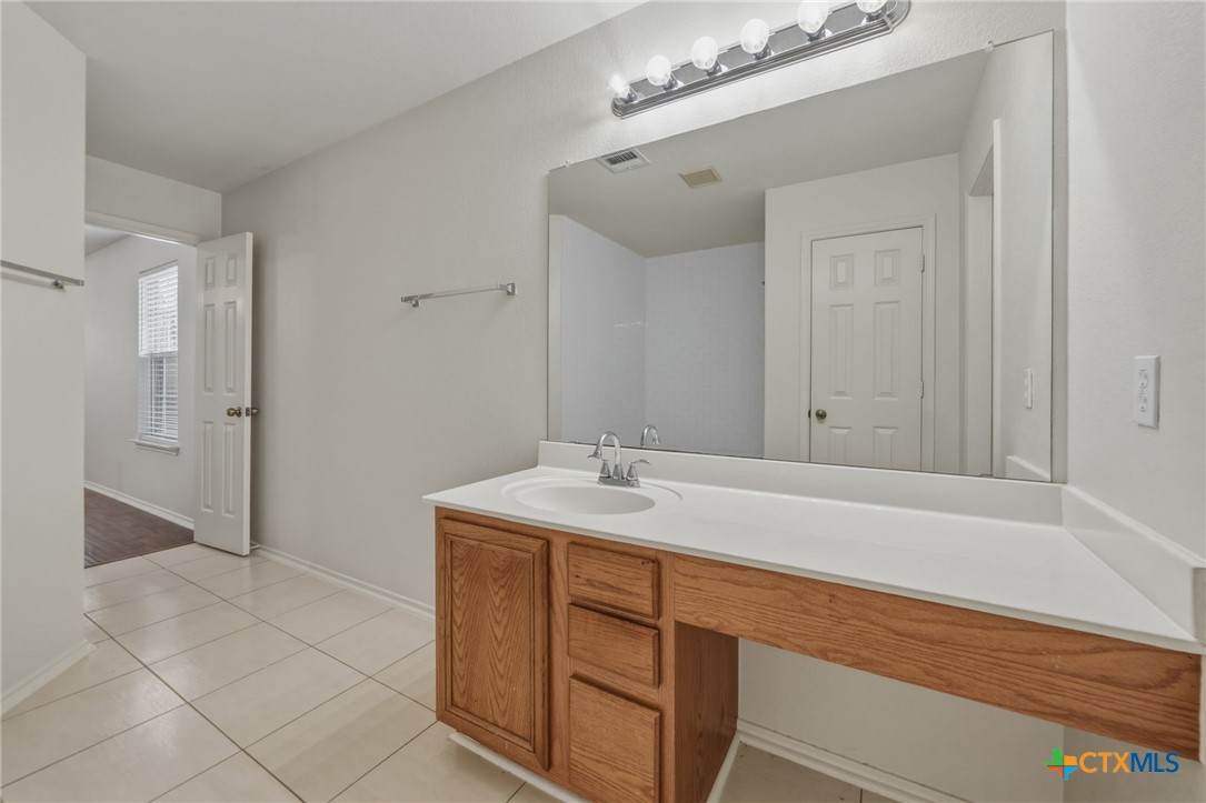 109 Comal Cove Elgin, TX 78621 - Photo 28 of 34 a bathroom with a sink and a mirror