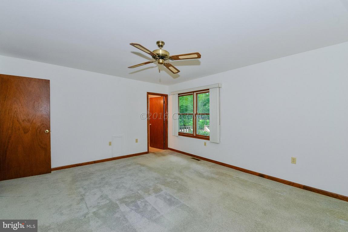 241 Windjammer Road Berlin, MD 21811 - Photo 22 of 38 an empty room with a window and a fan