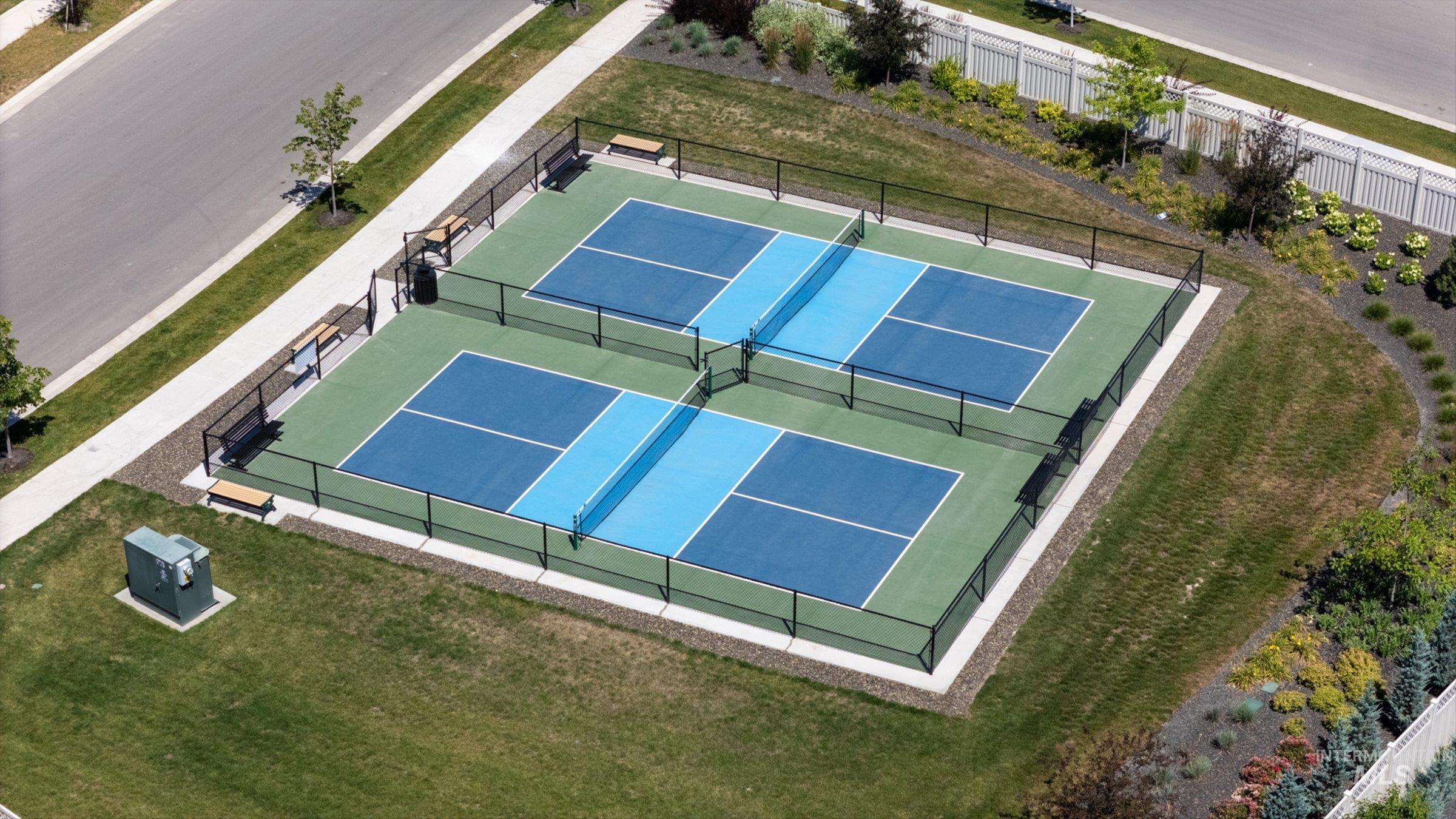 2172 Savoy Court Middleton, ID 83644 - Photo 44 of 46 Fenced pickleball courts featuring two full-size playing areas with a blue and green surface