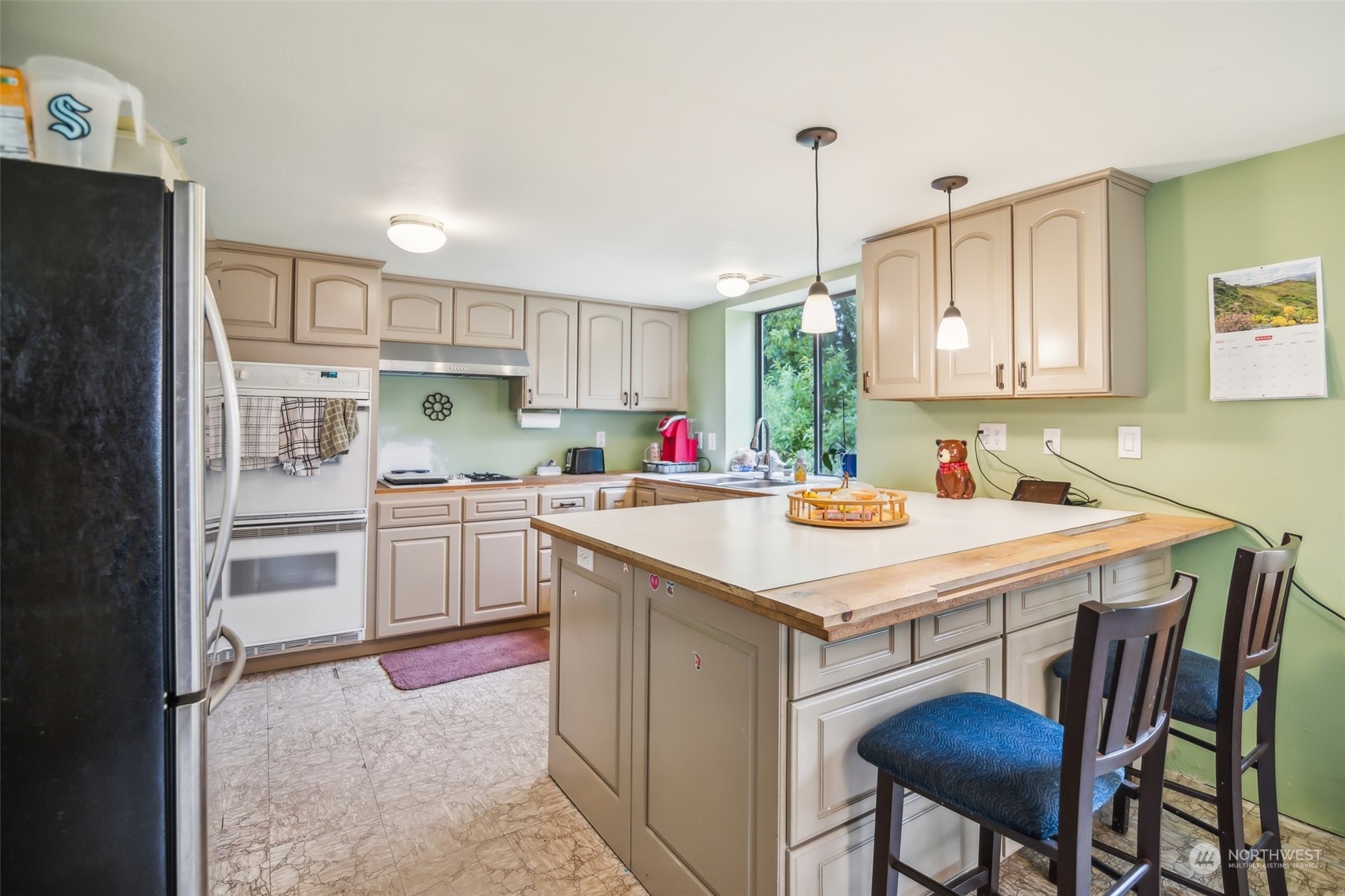 22824 7th Avenue Southeast Bothell, WA 98021 - Photo 7 of 21 a kitchen with kitchen island a stove a table and chairs in it