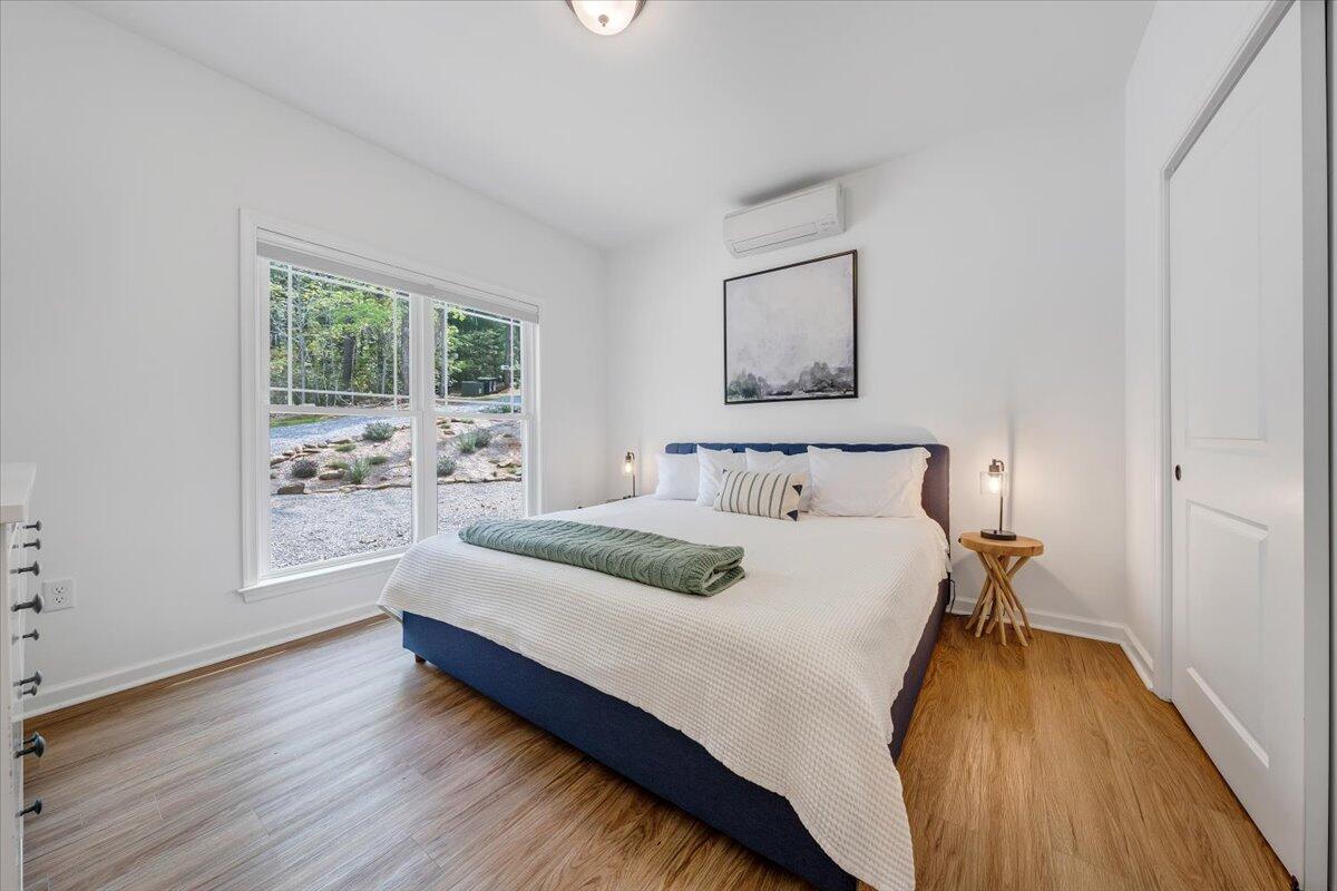 1373 Thomason Lane Goodview, VA 24095 - Photo 11 of 89 a spacious bedroom with a bed and a window
