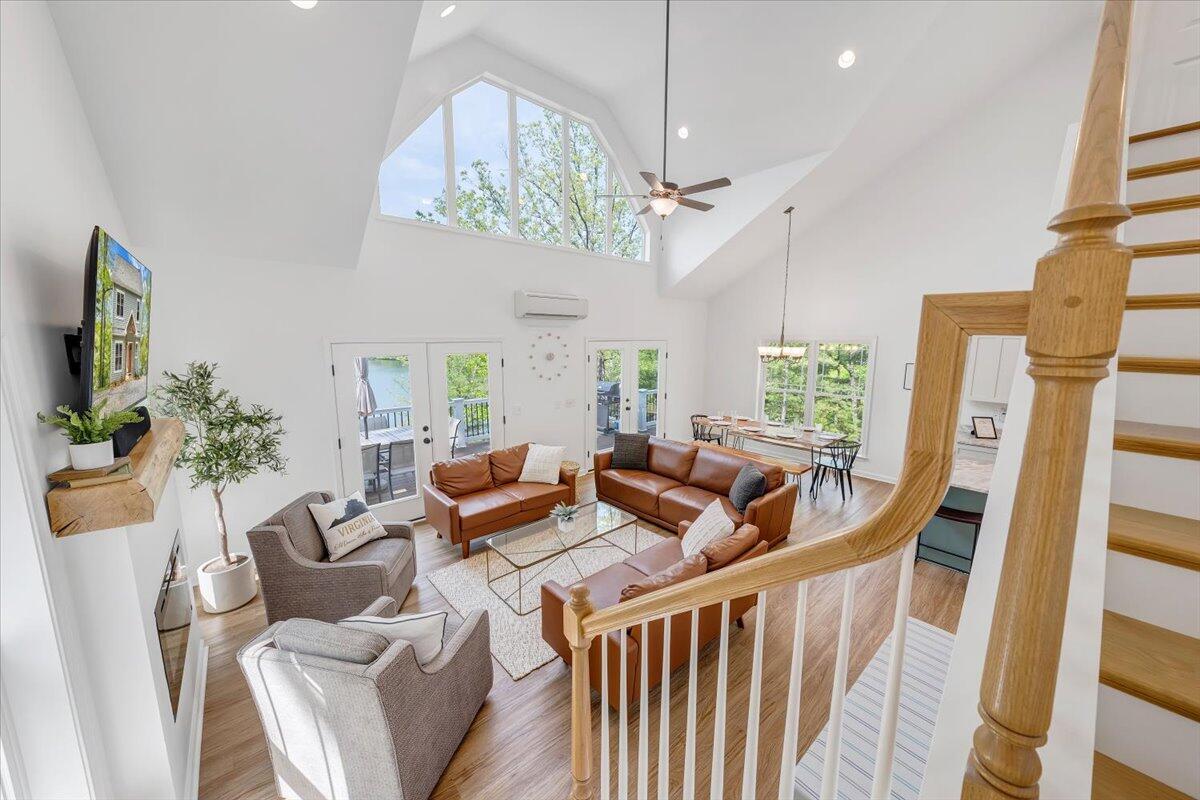 1373 Thomason Lane Goodview, VA 24095 - Photo 25 of 89 a living room with furniture a chandelier and a flat screen tv