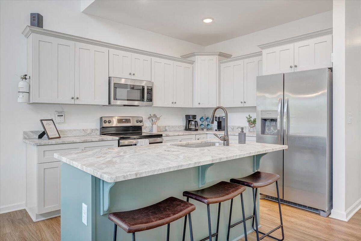 1373 Thomason Lane Goodview, VA 24095 - Photo 6 of 89 a kitchen with stainless steel appliances granite countertop a table chairs sink refrigerator and cabinets
