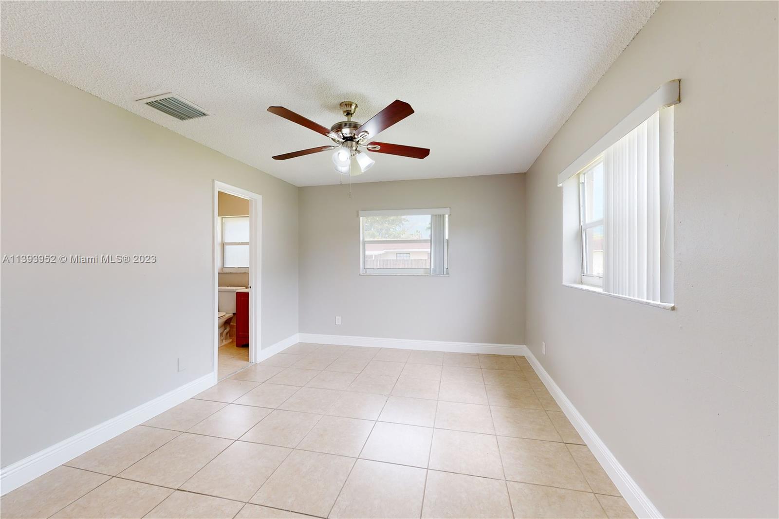 16813 Southwest 107th Place Miami, FL 33157 - Photo 11 of 28 a view of an empty room with a window